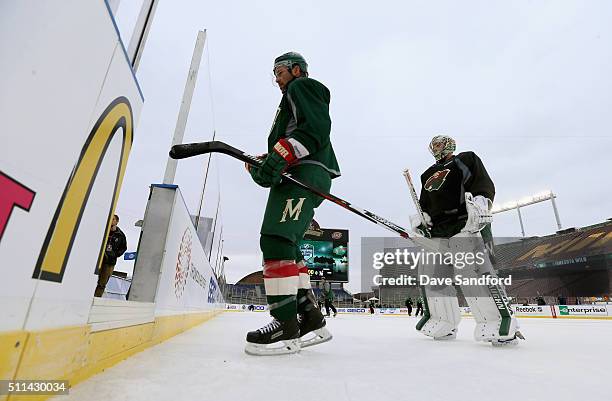 Chris Porter and goaltender Darcy Kuemper of the Minnesota Wild skate off the ice after practice for the 2016 Coors Light Stadium Series game between...