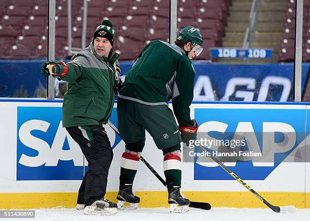 Interim head coach John Torchetti of the Minnesota Wild speaks to Charlie Coyle during practice day at the 2016 Coors Light Stadium Series on...