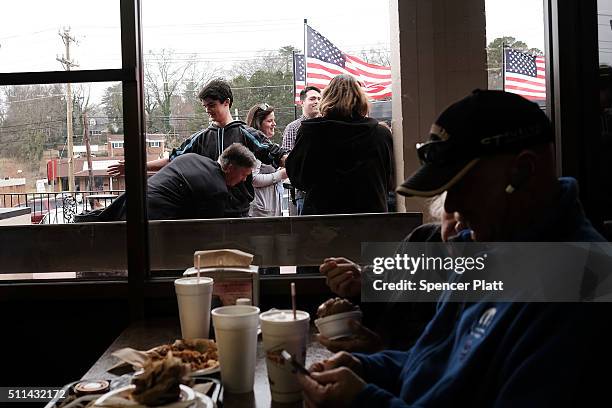 People are searched by the Secret Service as Republican presidential candidate Ben Carson visits voters in a restaurant during the Republican...