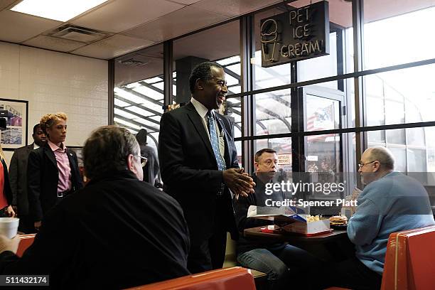 Republican presidential candidate Ben Carson visits voters in a restaurant during the Republican presidential primary on February 20, 2016 in...