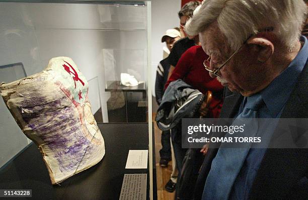 Man looks at the orthopedic corset with the sickle and hammer used by Mexican painter Frida Kahlo because of the ailment in her back, during the...