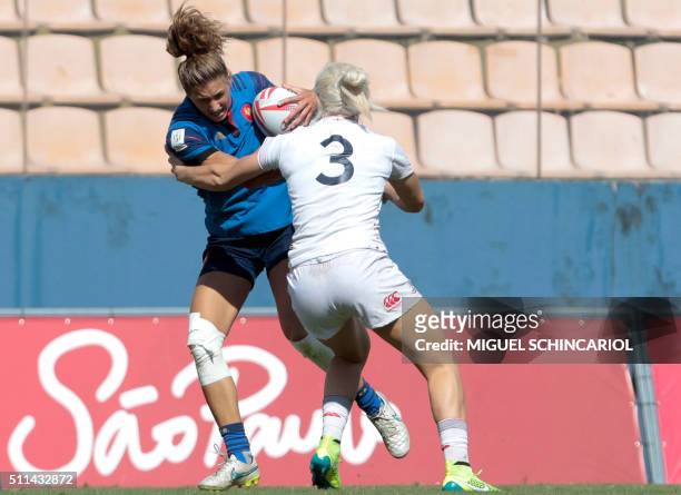 Una Guerin of France fights with Alice Richardson of England during their World Rugby Women's Sevens Series match in Barueri, some 30 km from Sao...