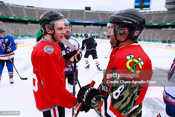 Patrick Kane of the Chicago Blackhawks speaks to a member of the Wounded Warrior hockey team during practice day for the 2016 Coors Light Stadium...