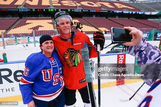Jonathan Toews of the Chicago Blackhawks poses for a photo with a member of the Wounded Warrior hockey team during practice day for the 2016 Coors...