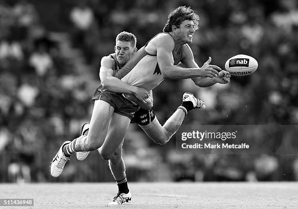 Kurt Tippett of the Swans handpasses the ball as he is tackled by Matthew White of the Power during the 2016 NAB Challenge AFL match between the...