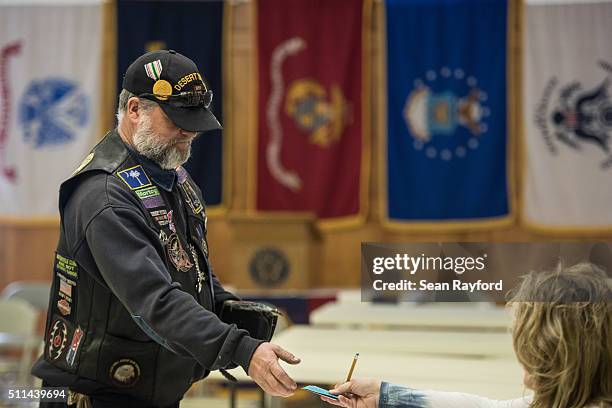 Republican primary voter Michael Rabun checks in at a polling location at American Legion Post 90 February 20, 2016 in West Columbia, South Carolina....