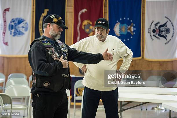 Michael Rabun chats with a fellow Republican primary voter at a polling location, American Legion Post 90, on February 20, 2016 in West Columbia,...