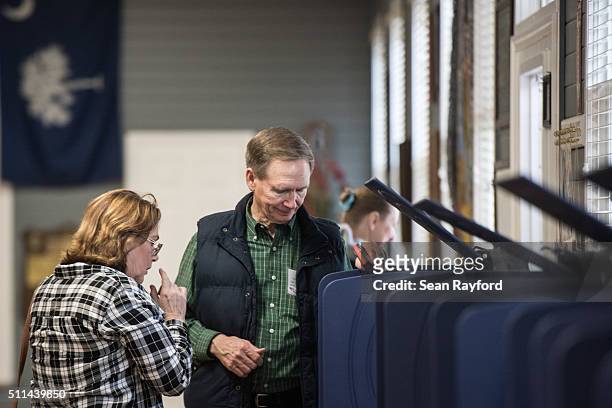Poll worker assists a Republican primary voter at American Legion Post 7 on February 20, 2016 in Lexington, South Carolina. Today's vote is...