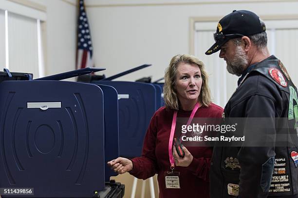 Poll worker assists Republican primary voter Michael Rabun at American Legion Post 90 on February 20, 2016 in West Columbia, South Carolina. Today's...