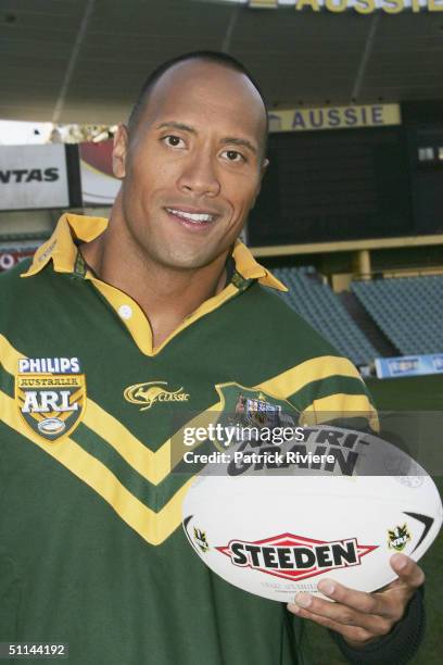 Actor Dwayne Johnson "The Rock" receives the Australian Rugby League official "Kangaroo"Jersey from a selection of national players at the Aussie...