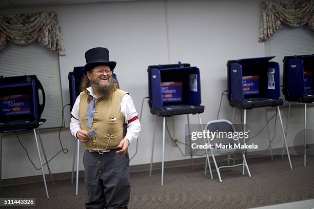 Wade Fulmer dressed in costume as a Civil War undertaker, shares a laugh with poll station workers at the Belvedere First Baptist Church polling...