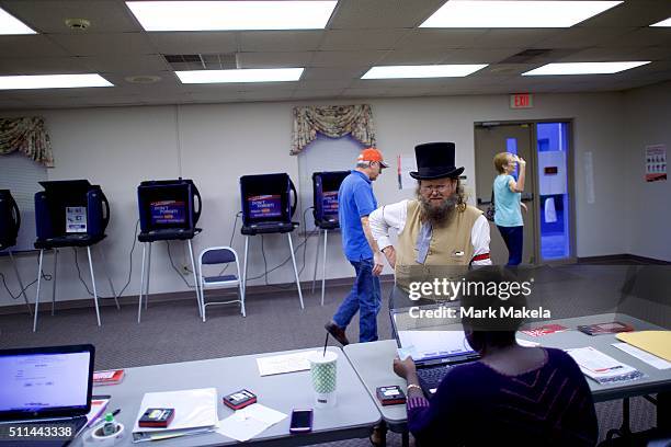 Wade Fulmer dressed in costume as a Civil War undertaker, registers to vote at the Belvedere First Baptist Church polling precinct after...