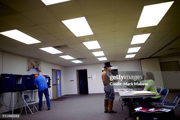 Wade Fulmer dressed in costume as a Civil War undertaker, registers to vote at the Belvedere First Baptist Church polling precinct after...