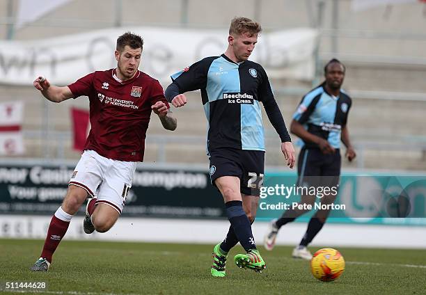 Jason McCarthy of Wycombe Wanderers plays the ball from James Collins of Northampton Town during the Sky Bet League Two match between Northampton...
