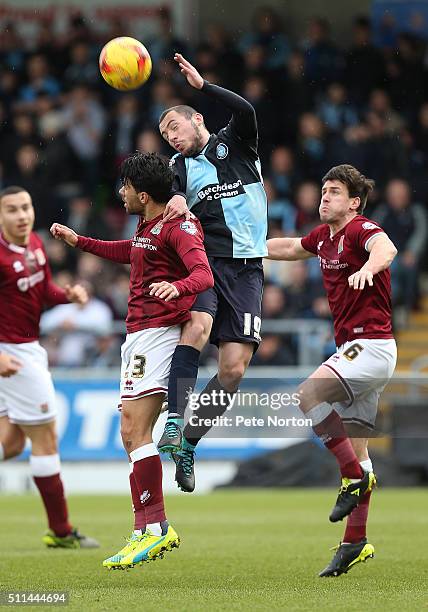 Michael Harriman of Wycombe Wanderers contests the ball with Danny Rose and David Buchanan of Northampton Town during the Sky Bet League Two match...