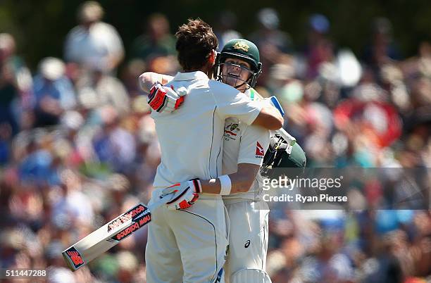 Joe Burns of Australia is congratulated by Steve Smith of Australia after reaching his century during day two of the Test match between New Zealand...