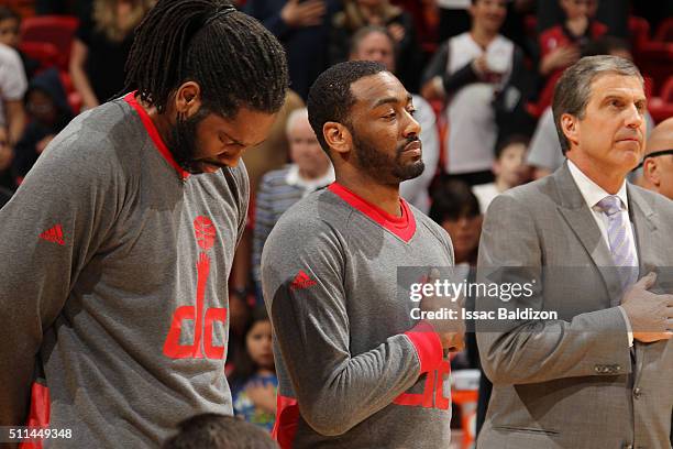 Nene of the Washington Wizards, John Wall of the Washington Wizards and head coach Randy Wittman of the Washington Wizards stand for the national...