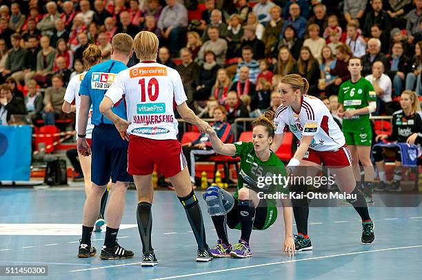 Nerea Pena Abauerra of FTC-Rail Cargo is helped back up on her feet by Larvik HK`s Karoline Dyhre Breivang and Gro Hammerseng-Edin during the Women's...