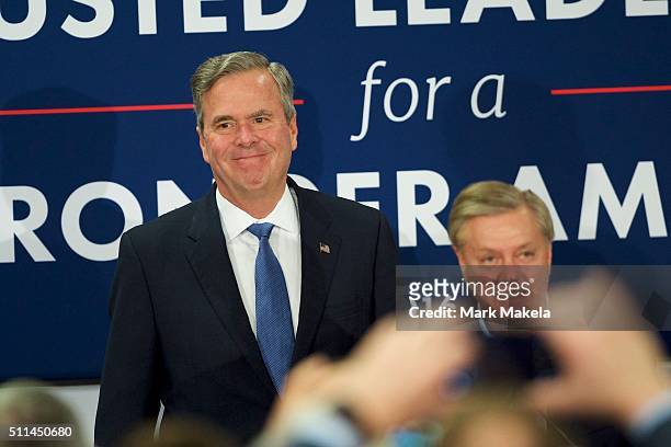 Jeb Bush takes the stage with supporter Lindsey Graham before announcing the suspension of his presidential campaign at an election night party at...