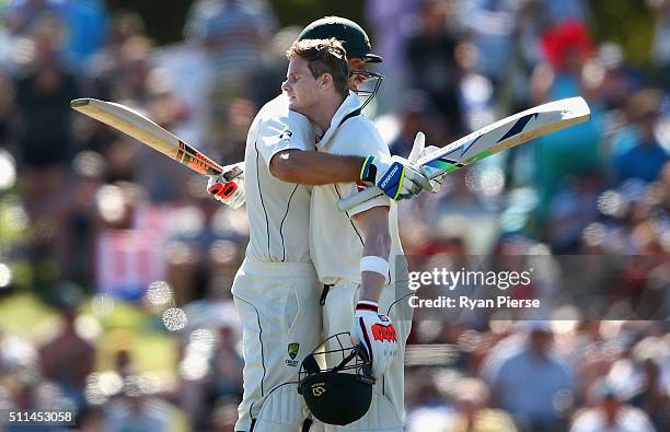 Steve Smith of Australia is congratulated by Joe Burns of Australia after reaching his century during day two of the Test match between New Zealand...