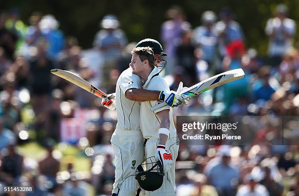 Steve Smith of Australia is congratulated by Joe Burns of Australia after reaching his century during day two of the Test match between New Zealand...