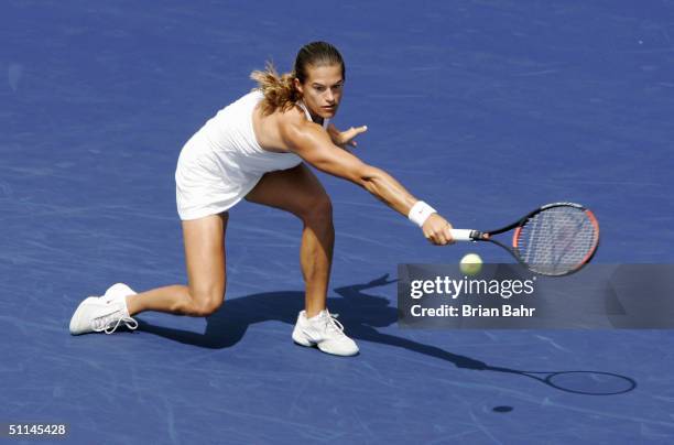 Amelie Mauresmo of France reaches out for a serve from Elena Bovina of Russia during the third round of the Rogers Cup tennis on August 5, 2004 at...