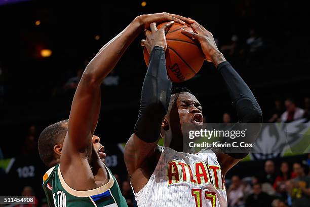 Dennis Schroder of the Atlanta Hawks has his shot blocked by Khris Middleton of the Milwaukee Bucks in the second overtime of their 117-109 loss at...