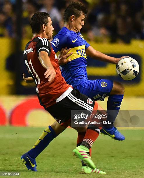 Maximiliano Rodriguez of Newell's fights for the ball with Adrian Cubas of Boca Juniors during the 4th round match between Boca Juniors and Newell's...