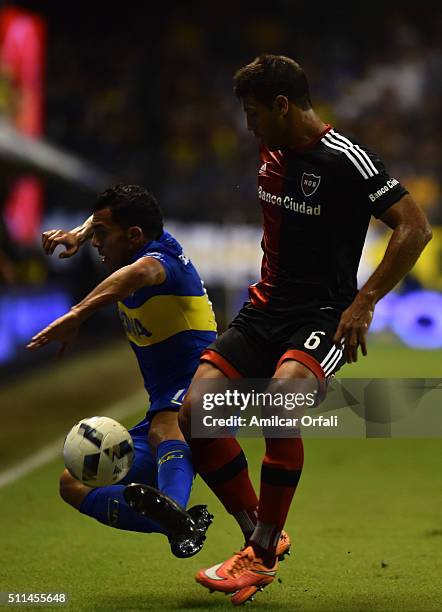 Carlos Tevez, of Boca Juniors fights for the ball with Sebastian Dominguez of Newell's during the 4th round match between Boca Juniors and Newell's...