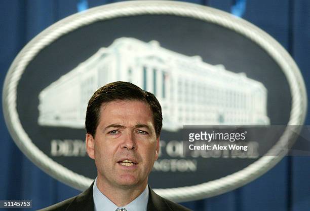 Deputy Attorney General James B. Comey speaks during a news conference August 5, 2004 at the Department of Justice in Washington, DC. Two men from...