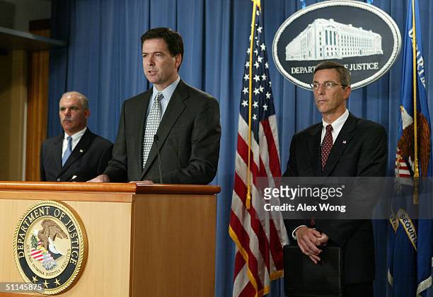 Deputy Attorney General James B. Comey speaks as FBI Assistant Director for Counterterrorism Gary Bald and U.S. Attorney for the Northern District of...