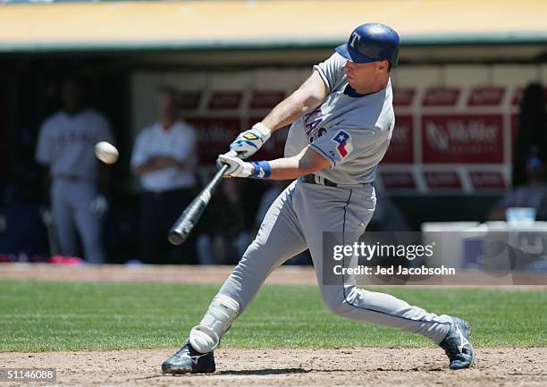 Laynce Nix of the Texas Rangers swings at the pitch during the game against the Oakland Athletics at the Network Associates Coliseum on July 25, 2004...