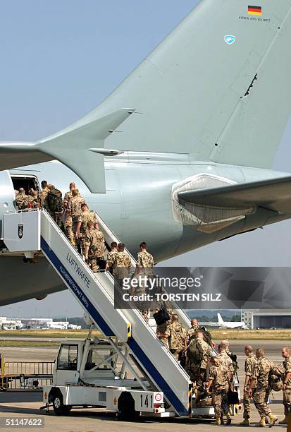 Soldiers of the Eurocorps board an aircraft in Cologne 06 August 2004 before flying out of Germany for Afghanistan where they are to take command of...
