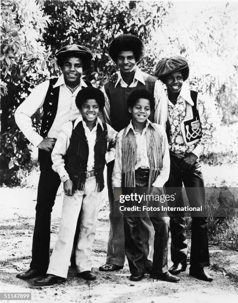 Portrait of American pop group the Jackson 5 standing outdoors, early 1970s. From left, back row Tito Jackson, Jackie Jackson, and Jermaine Jackson;...