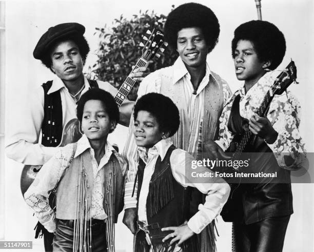 Portrait of American pop group the Jackson 5 standing outdoors, early 1970s. From left, back row Tito Jackson, Jackie Jackson, and Jermaine Jackson;...