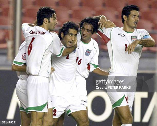 Iran's players mob Mehdi Mahdavikia for setting up the second goal, scored by teammate Ali Karimi during the Asian Cup third-placing match 06 August...