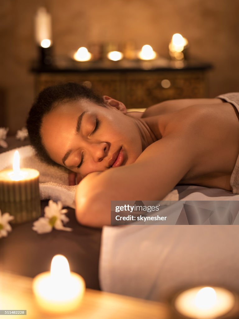 African American woman with eyes closer enjoying at spa.