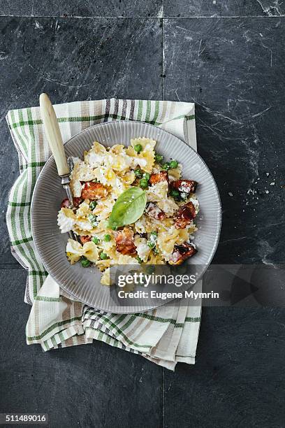 farfalle pasta with pancetta and ricotta - pancetta stock pictures, royalty-free photos & images