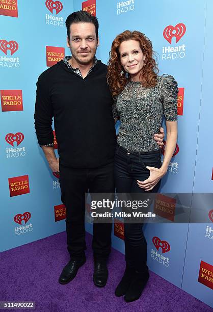 Actors Bart Johnson and Robyn Lively pose backstage during the first ever iHeart80s Party at The Forum on February 20, 2016 in Inglewood, California.