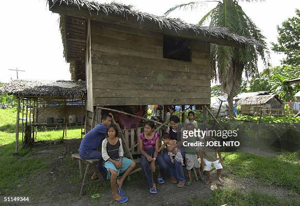 Muslem family rests under shade of a wooden hut at an evacuation camp in the town of Pagalungan in the troubled island of Mindanao in the southern...