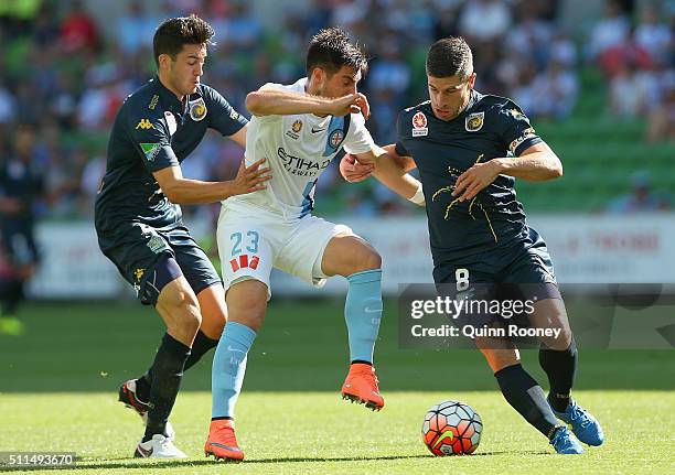 Bruno Fornaroli of City is tackled by Harry Ascroft and Nick Montgomery of the Mariners during the round 20 A-League match between Melbourne City FC...