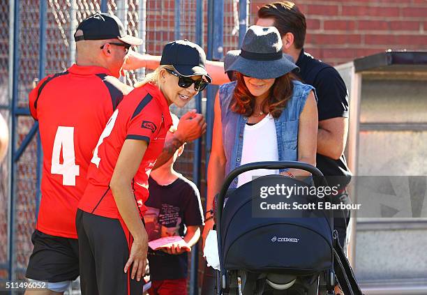 Carrie Bickmore talks with Michelle Bridges as they look at her baby Axel in his pram during the Medibank Melbourne Celebrity Twenty20 match at North...