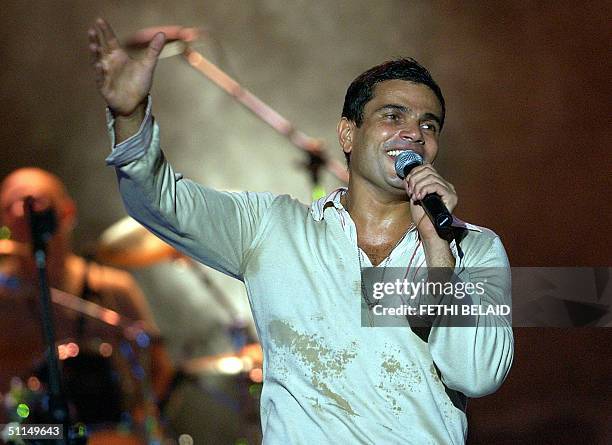 Egyptian singer Amro Diab performs late 06 August 2004 during the Carthage international festival in the Roman theatre. AFP PHOTO/FETHI BELAID