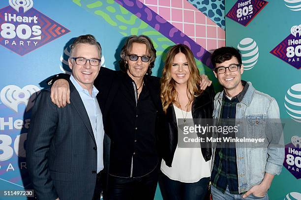 Musician Rick Springfield poses with iHeartRadio personalities Sean Valentine, Jillian Escoto and Kevin Manno backstage during the first ever...