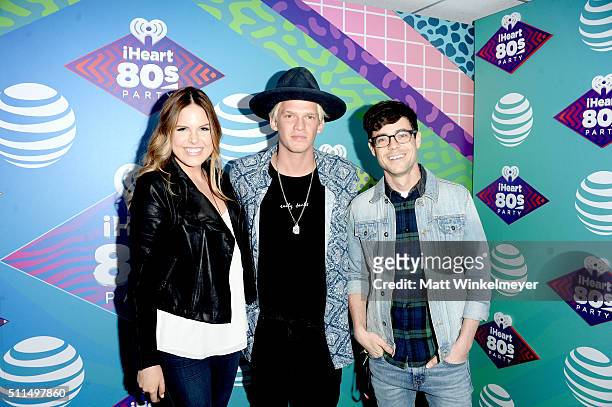 Singer Cody Simpson poses with iHeartRadio personalities Jillian Escoto and Kevin Manno backstage during the first ever iHeart80s Party at The Forum...