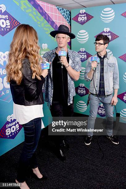 Singer Cody Simpson speaks with iHeartRadio personalities Jillian Escoto and Kevin Manno backstage during the first ever iHeart80s Party at The Forum...