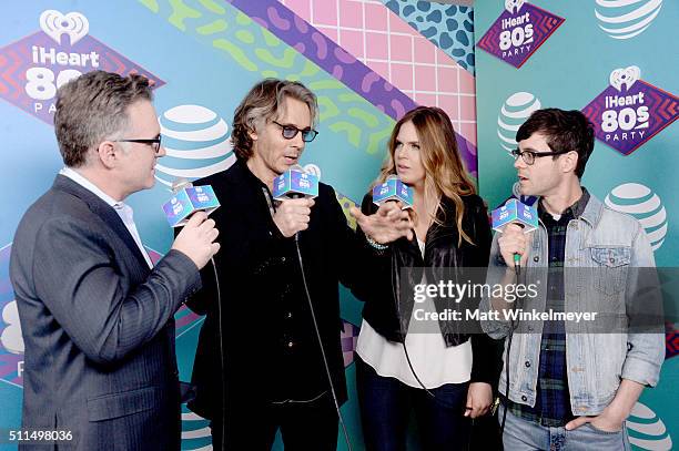 Musician Rick Springfield speaks with iHeartRadio personalities Sean Valentine, Jillian Escoto, and Kevin Manno backstage during the first ever...