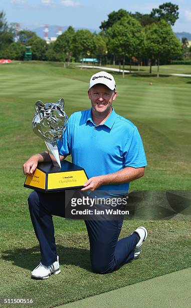 Marcus Fraser of Australia celebrates with the trophy after winning the fourth round of the Maybank Championship Malaysia at Royal Selangor Golf Club...