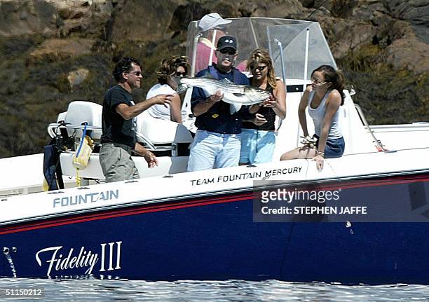 President George W. Bush holds a stripped bass that his daughter Jenna caught off the coast of Kennebunkport, Maine, 07 August, 2004. Bush was...