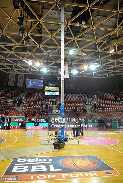 Officials stand on the court underneath a leak in a water pipe in the ceiling prior to the Beko BBL TOP FOUR Third Place Game between Brose Baskets...